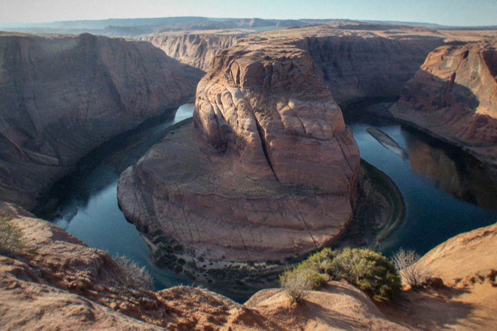 The Colorado River curving around the sandstone walls of Horseshoe Bend