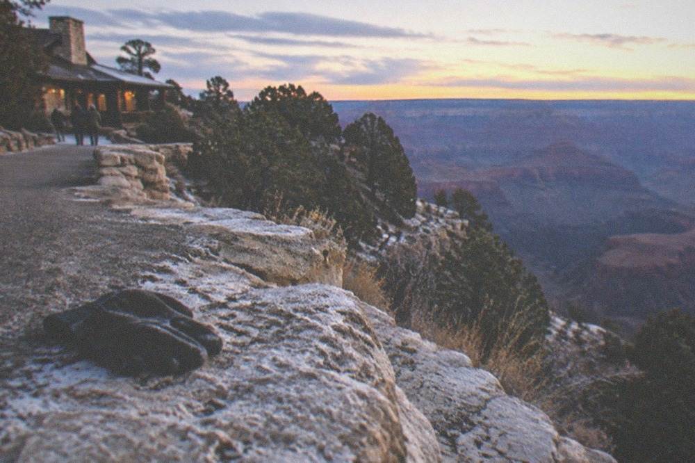A wide canyon vista with layered rock walls in warm evening light