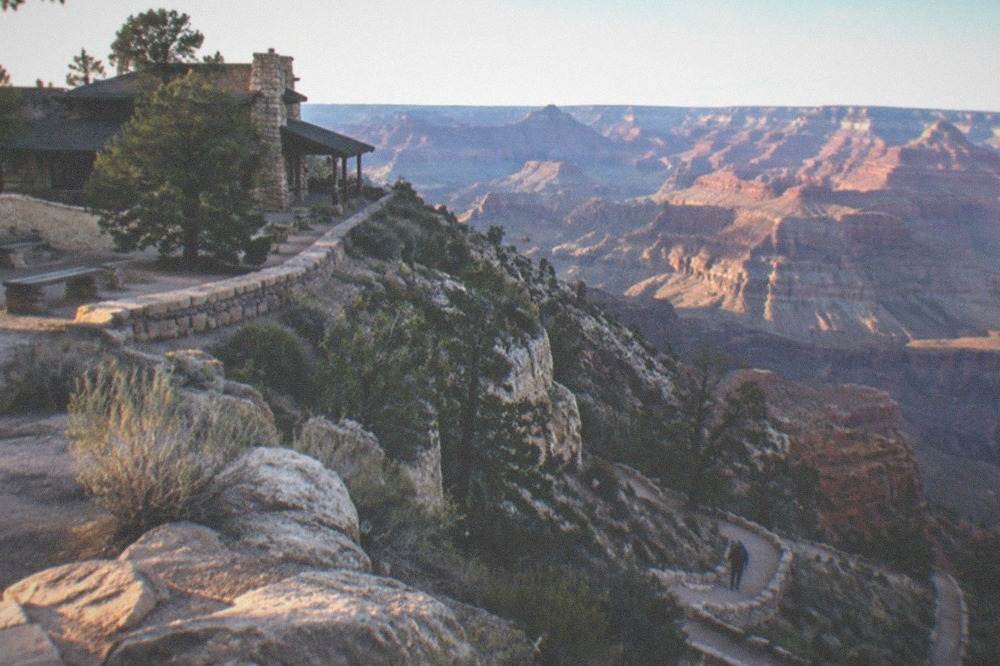 Canyon rim in late afternoon light with long shadows across the rock layers